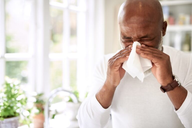 Man blowing nose