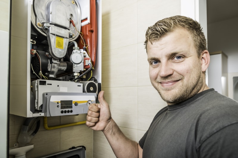 technician performing furnace maintenance